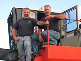 Cole brothers standing in front of a forwarder.