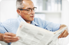 Older man reading a newspaper