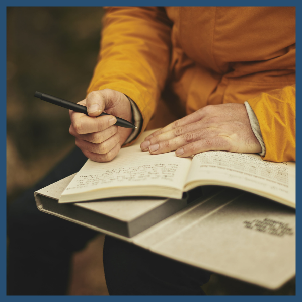 person writing in a journal