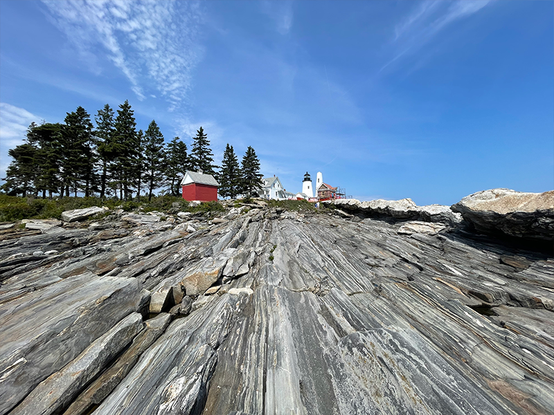 A rocky outcrop leading up to a lighthouse