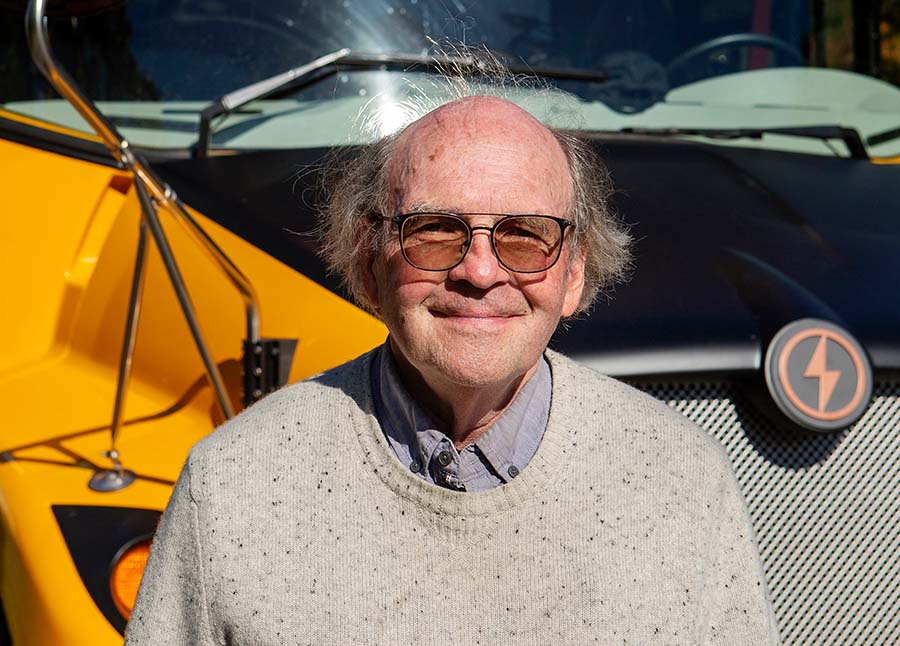Doug Van Gorder standing in front of the electric school bus