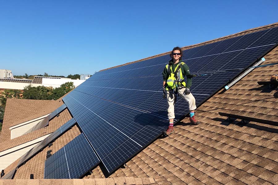 Jessie Rule on a roof installing solar panels