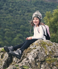 Girl Hiker Sitting on Mountain Top.